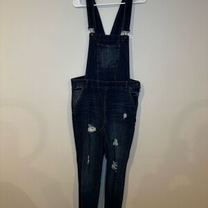 Dark denim women’s size large, distressed knees and raw hem. Great condition.